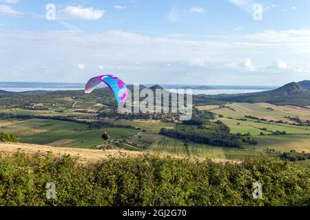 Paraglider over the mountains of lake Balaton in Hungary on a summer day. Stock Photo