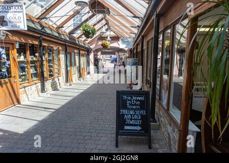 Interior of Great Torrington Pannier Market, Shops and Glass Roof Detail Looking Towards the Main Town Entrance and Torrington Square Stock Photo