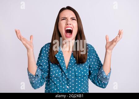 Photo of yell angry brunette hair millennial lady hands up wear blue shirt isolated on grey color background Stock Photo