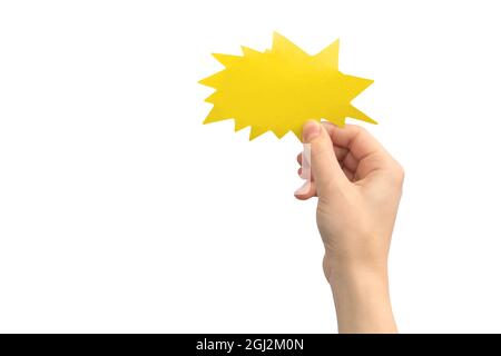 Hand with blank speech bubble in shape of boom or lightning, yellow color, isolated on a white background. Concept of giving feedback, communication a Stock Photo