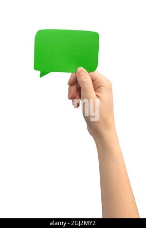 Blank green speech bubble in female hand, isolated on white background Stock Photo