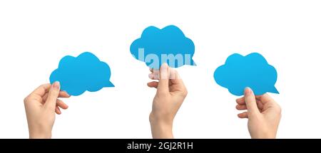 Group of blue speech bubbles in hands, empty cardboard and paper mockup banner, giving feedback concept, isolated on a white background Stock Photo