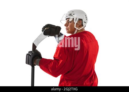 Back view. Cropped close-up portrait of male professional hockey player in special uniform isolated over white background. Back view Stock Photo
