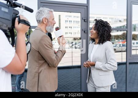 reporter interviewing pretty african american businesswoman
