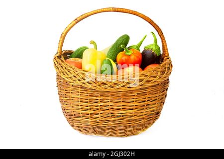 Assorted vegetables in a wicker basket isolated on white Stock Photo