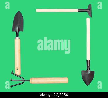 Frame made of garden hand tools on green Stock Photo