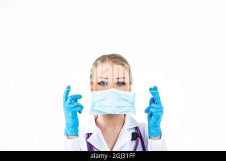 Woman wearing an anti virus protection mask to prevent others from corona COVID-19 and SARS cov 2 infection. The woman puts on a protective medical Stock Photo