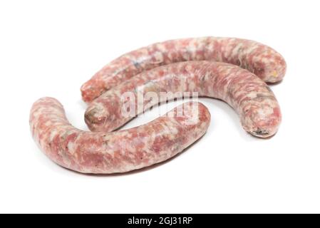 Three crude sausages with mushrooms on a white background Stock Photo