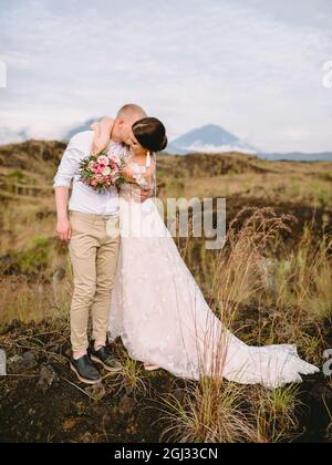 February 14, 2021. Bali, Indonesia. Happy couple posing outdoor. Wedding day of bride in wedding dress. Stock Photo