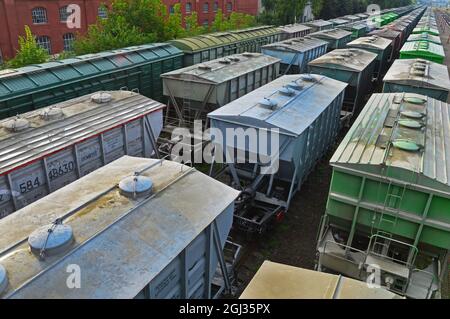 Four railway trains stand on the spare tracks of the station Stock Photo