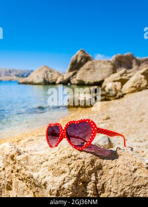 Red sunglasses glasses Beritnica beach near Metajna on Pag island in Croatia Europe Stock Photo