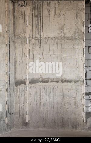 Concrete wall filled with wire mesh for further plastering. Stock Photo