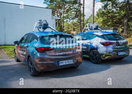 Two Google Street View cars parked in rural location. Google map vehicles are mapping roads worldwide. Stock Photo