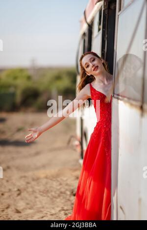 Young beautiful woman in red dress is traveling with bus or train. . High quality photo Stock Photo