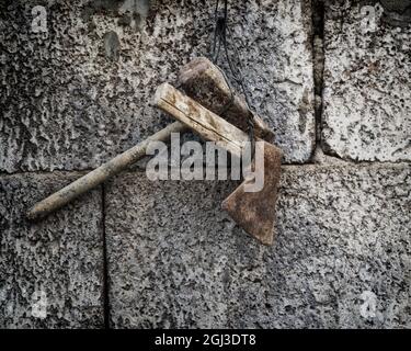 Closeup shot of old tools hanging on the wall Stock Photo