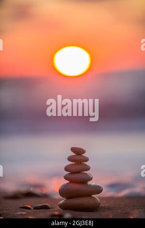 Stones balance on beach, sunrise shot Stock Photo