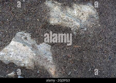 Rough rough surface of marble stone, breaking through marble chips. For use as abstract backgrounds and textures. Stock Photo