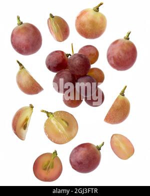 Falling red grape , isolated on white background, selective focus Stock Photo