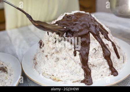 Cake making process. Prepared chocolate cake with sour cream is poured with chocolate icing. Step by step recipe for chocolate cake. Series. Baking co Stock Photo