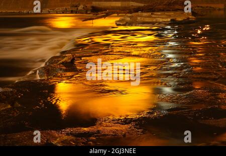 Night reflections on the Miami River. Light provided from the Dayton Masonic Center. Dayton, Ohio, USA. Stock Photo