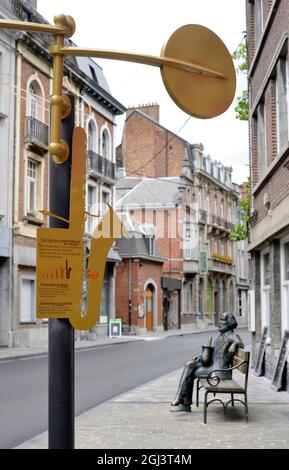 Dinant, Belgium 08-17-2014 sculpture of the saxophone inventor Adolphe Sax in the street with contrabass sax sign Stock Photo