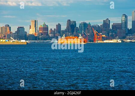 A Staten Island ferry boat crossing in front of Governor's Island in New York City's upper bay on a sunny day -01 Stock Photo