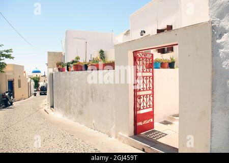 A cobblestone street in the traditional village of Megalochori in Santorini, Greece. Stock Photo