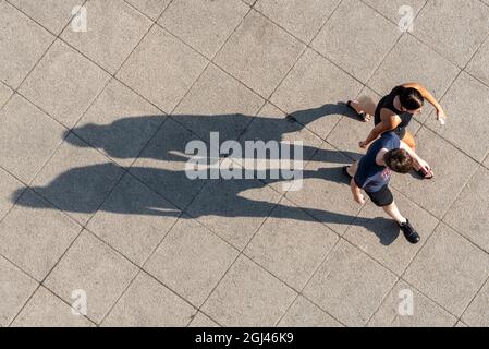 Long shadows of two people from above - aerial Stock Photo - Alamy