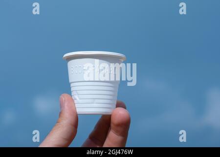 Man hand hold biodegradable eco friendly plastic glass,environment sustainability packaging Stock Photo