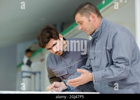 modern industrial machine operators working in factory Stock Photo