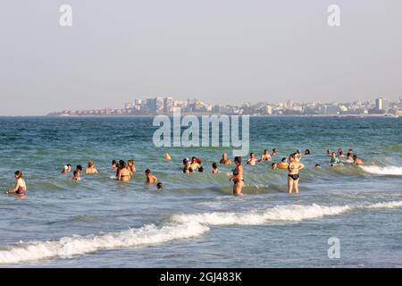 NAVODAR, ROMANIA - Aug 08, 2021: The tourists on the beach in Mamaia Nord, Navodar, Romania Stock Photo