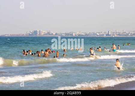 NAVODAR, ROMANIA - Aug 08, 2021: The tourists on the beach in Mamaia Nord, Navodar, Romania Stock Photo