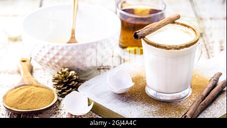 ingredients for Christmas recipes, how to make Christmas eggnog with eggs, liqueur, cinnamon and chestnuts Stock Photo