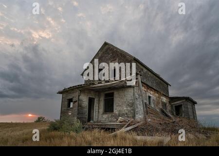 Prairie Storm Canada Summer time clouds abandoned building Stock Photo