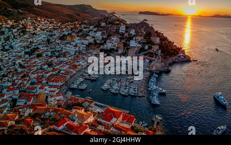 Aerial drone panoramic photo of the picturesque port and main village of Hydra (or Ydra) island at sunset. Hydra is a top tourist destination with neo Stock Photo
