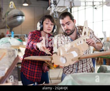 Team creating airplane models Stock Photo