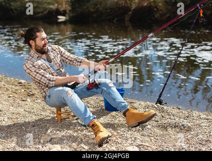 Person Holding Fishing Rod in Front of a River · Free Stock Photo