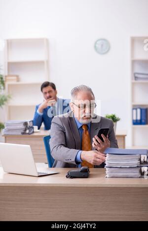 Two colleagues working at workplace Stock Photo