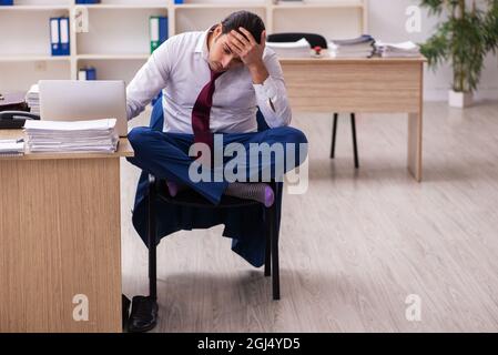 Young businessman employee doing yoga exercises during break Stock Photo