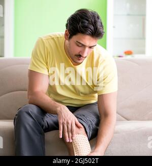 The man applying pepper capsicum plaster to relieve pain Stock Photo