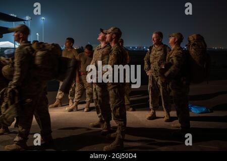 U.S. Air Force Airmen from the 380th Air Expeditionary Wing, board an HC-130J Combat King II aircraft  at Al Dhafra Air Base, United Arab Emirates, to forward deploy to an undisclosed location in Southwest Asia in support of the noncombatant evacuation operation, Aug 25, 2021. The Department of Defense is committed to supporting the evacuation of American citizens, Special Immigrant Visa applicants and other at-risk individuals from Afghanistan. (U.S. Air Force photo by Master Sgt. Wolfram M. Stumpf) Stock Photo