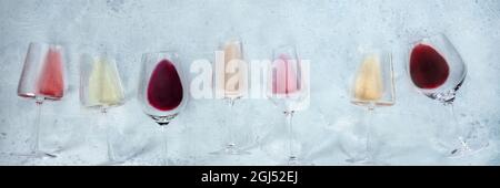 Wine panoramic banner with glasses of rose, red, and white wine, shot from above with copy space. Tasting event Stock Photo