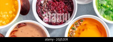 Healthy vegan cream soups panorama, vegetable detox banner, overhead flat lay shot of an assortment of dishes Stock Photo