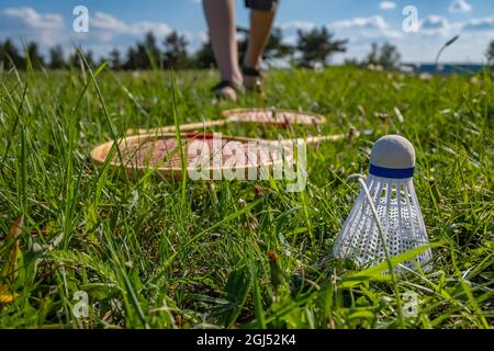 view of a badminton shuttlecock lying on the green grass in a meadow Stock Photo