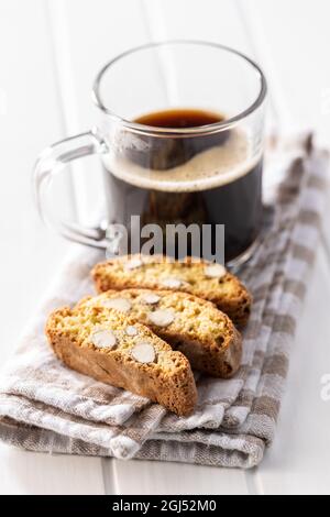 Italian cantuccini cookies and coffee cup. Sweet dried biscuits with almonds on white table. Stock Photo