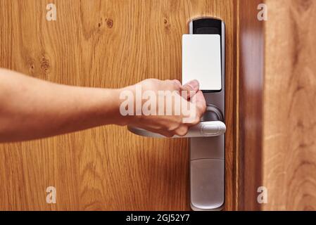 Hand open digital door lock with key card. Security alarm concept in hotel room Stock Photo