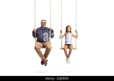 Happy grandfather and granddaughter playing on swings isolated on white background Stock Photo
