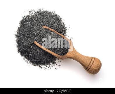 Wooden scoop of black natural salt isolated on white. Top view Stock Photo
