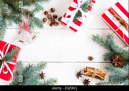 New year wooden background with spruce branches, anise stars, cinnamon sticks, gifts in festive packaging with a copy of the space Stock Photo