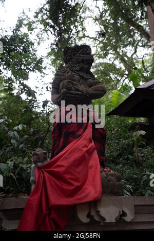 Vertical shot of a monkey statue in the Sacred Monkey Forest Sanctuary Ubud in Bali, Indonesia Stock Photo